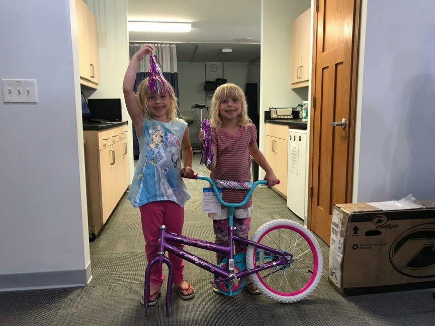 Two girls with a bike