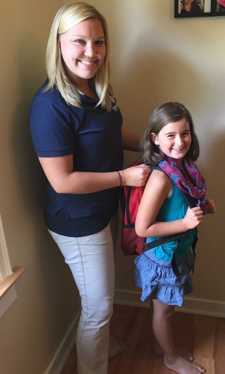 Therapist and child with backpack